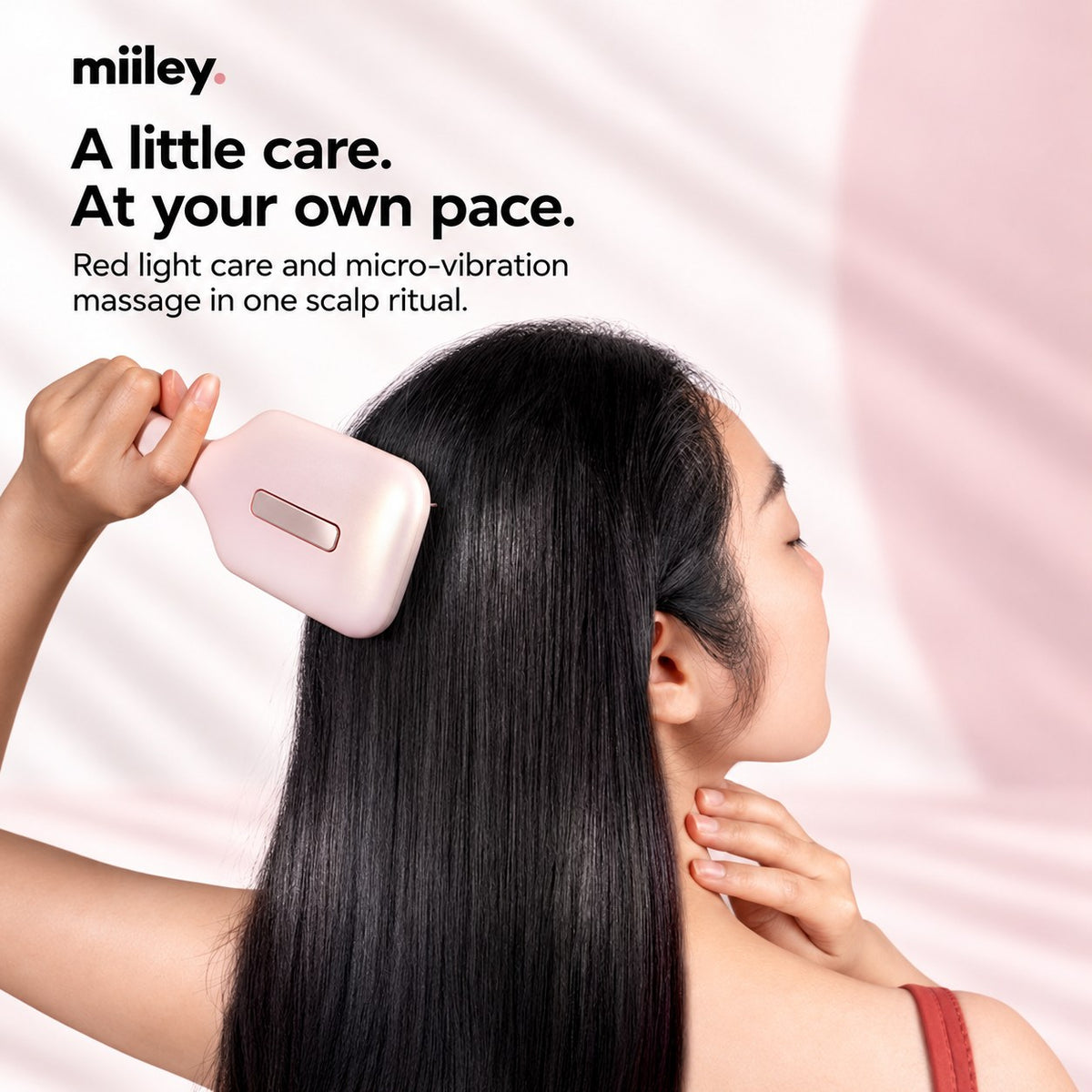Woman using the Miiley Red Light Scalp Massage Comb